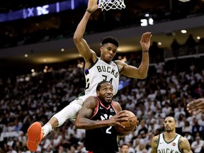 Toronto Raptors forward Kawhi Leonard (2) gets fouled by Milwaukee Bucks forward Giannis Antetokounmpo (34) during second half in Milwaukee on Wednesday, May 15, 2019.