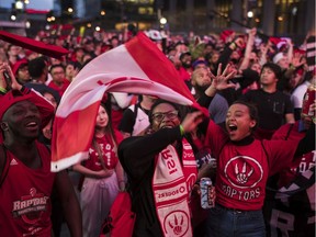 Toronto Raptors fans sing the Canadian national anthem outside the Scotiabank Arena, at what's dubbed "Jurassic Park," during the NBA finals debut against the Golden State Warriors in Toronto on Thursday, May 30, 2019.