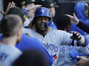 Toronto Blue Jays' Vladimir Guerrero Jr., celebrates with teammates after hitting a two-run home run during the eighth inning of a baseball game against the Chicago White Sox in Chicago, Sunday, May 19, 2019.