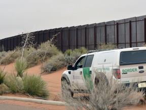 In this Jan. 5, 2016, file photo, a U.S. Border Patrol vehicle drives next to a U.S-Mexico border fence in the booming New Mexico town of Santa Teresa.