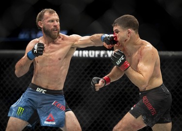 Donald Cerrone (left) punches Al Iaquinta during their main event lightweight bout at UFC Fight Night on Saturday at the Canadian Tire Centre in Ottawa. Cerrone won by unanimous decision.