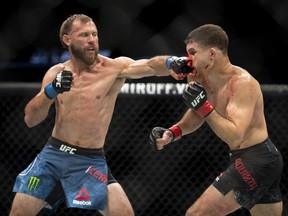 Donald Cerrone (left) punches Al Iaquinta during their main event lightweight bout at UFC Fight Night on Saturday at the Canadian Tire Centre in Ottawa. Cerrone won by unanimous decision.