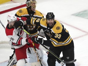 Zdeno Chara, seen here giving Carolina Hurricanes captain Justin Williams a mouthful of mitt, was one of four Boston Bruins who were a part of the 2010 team that blew a seemingly insurmountable 3-0 lead to the Philadelphia Flyers in the conference semifinals. (Charles Krupa/The Associated Press)