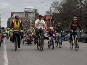 A group of cyclists, including Chris Bradshaw's nephew Landon Bradshaw (centre, beige shirt) take part in a "critical mass" cycling trip down Richmond Rd. in celebration of Chris's life.