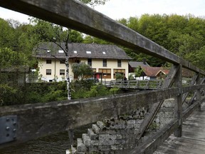 A guesthouse is pictured at the river 'Ilz' in Passau, Germany, Monday, May 13, 2019. Police investigating the mysterious death of three people whose bodies were found with crossbow bolts inside at the hotel in Bavaria on Saturday, May 11, 2019.