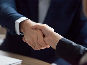 Businessman and businesswoman in suits handshaking showing partner respect, gender equality, female male hands shake as trust loyalty collaboration concept, gratitude, good relations, close up view