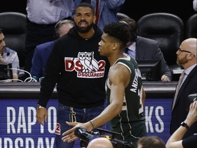 Drake gives it to Milwaukee Bucks Giannis Antetokounmpo at the end of Game 4. JACK BOLAND/TORONTO SUN