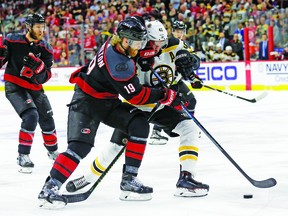 Carolina Hurricanes' Dougie Hamilton (19) and Boston Bruins' David Backes (42) chase the puck during the first period in Game 4 of the NHL hockey Stanley Cup Eastern Conference final series in Raleigh, N.C., Thursday, May 16, 2019. (AP Photo/Gerry Broome)