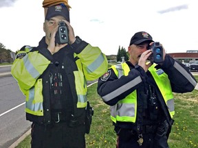 Life-size cutout of 'Constable Scarecrow' on left, with traffic officer Const. Luc Mongeon on the right.