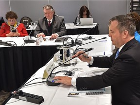 Premier Jason Kenney adjusts his microphone just before speaking at the tanker ban hearings known as Bill C-48 in Edmonton on April 30, 2019.