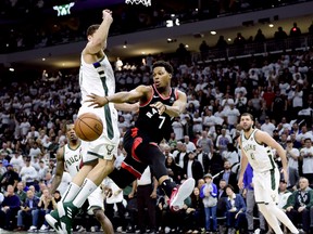 Raptors guard Kyle Lowry (7) dishes offl under pressure from Milwaukee Bucks forward Nikola Mirotic during Game 1 of their Eastern Conference final playoff series in Milwaukee on Wednesday night. (Frank Gunn/The Canadian Press)