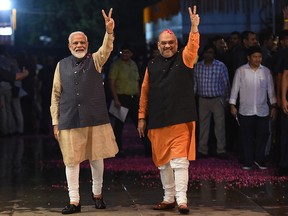 Indian Prime Minister Narendra Modi (L) and president of the ruling Bharatiya Janata Party (BJP) Amit Shah gesture as they celebrate the victory in India's general elections, in New Delhi on May 23, 2019.