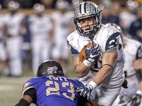 FILES: New Hampshire running back Dalton Crossan runs the ball as James Madison cornerback Charles Tutt attempts to block during an NCAA college football game in Harrisonburg, Va., Saturday, Dec. 3, 2016.