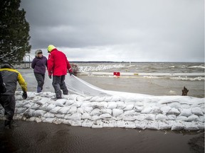 People were building a wall of sandbags and plastic to try to hold back the Ottawa River near the Britannia Yacht Club on Saturday, April 27, 2019.   Ashley Fraser/Postmedia