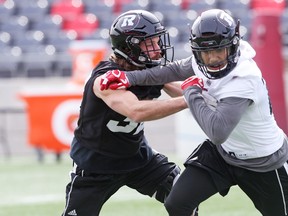 Keith Sanscartier (left) and R.J. Shelton take part in Redblacks’ mini camp drills in April. Shelton is battling for a roster spot. (JEAN LEVAN/POSTMEDIA NETWORK)