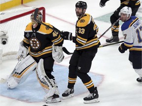 Bruins goaltender Tuukka Rask and defenceman Zdeno Chara defend the net as Blues winger Jaden Schwartz, right, skates by during the third period of Game 1 on Monday night.