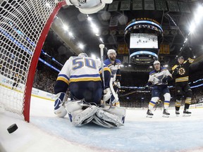 Boston Bruins' Charlie Coyle, right, celebrates his power play goal against St. Louis Blues goaltender Jordan Binnington (50) during the first period in Game 2 of the NHL hockey Stanley Cup Final against the St. Louis Blues, Wednesday, May 29, 2019, in Boston. (Bruce Bennett/Pool via AP)