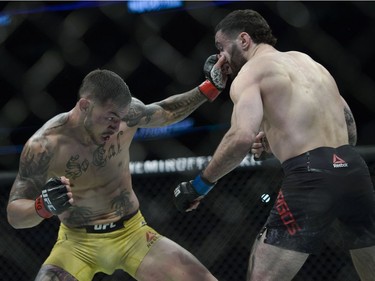 Cub Swanson (left) fights Shane Burgos (right) during UFC Fight Night Featherweight bout held at Canadian Tire Centre on Saturday.