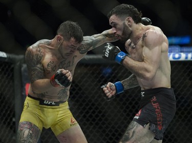 Cub Swanson (left) fights Shane Burgos (right) during UFC Fight Night Featherweight bout held at Canadian Tire Centre on Saturday.