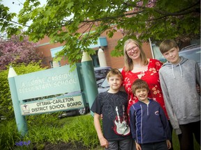 Tanya Hein and her children, 12-year-old Joshua Hein, 10-year-old Spencer Hein and six-year-old Elliot Hein in front of A. Lorne Cassidy Elementary School, Friday May 31, 2019.