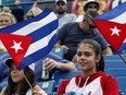 A fan cheers on the Cuban team against the Ottawa Champions in a Can-Am League game in Ottawa on Sunday.
