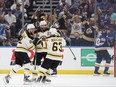 Patrice Bergeron of the Boston Bruins is congratulated by his teammates David Pastrnak and Brad Marchand after scoring a first period goal against the St. Louis Blues in Game 3 of the 2019 NHL Stanley Cup Final at Enterprise Center on June 1, 2019 in St Louis, Miss. (Bruce Bennett/Getty Images)