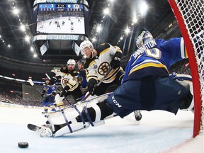 Charlie Coyle of the Bruins scores a first-period goal against Jordan Binnington of the Blues in Game 4 on Monday night.