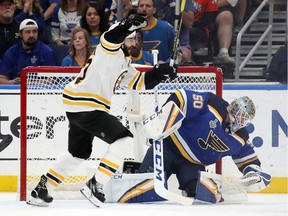 Patrice Bergeron of the Bruins celebrates a first-period goal by Brad Marchand (not shown) past Jordan Binnington of the Blues in Game 6 on Sunday night.