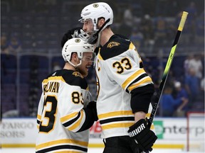 Karson Kuhlman celebrates with Bruins captain Zdeno Chara after their team's 5-1 win in St. Louis on Sunday night, extending the Stanley Cup final against the Blues to Game 7 in Boston on Wednesday night.