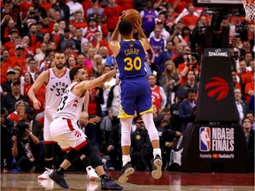 Stephen Curry of the Warriors attempts a shot against the Raptors in the second half of Game 5 in Toronto on Monday night.