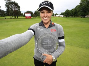 Brooke Henderson of Smiths Falls takes a selfie with the winner's trophy after claiming victory in the Meijer LPGA Classic on Sunday.