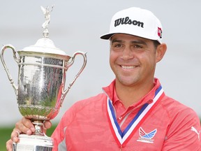 Gary Woodland of the United States poses with the trophy after winning the 2019 U.S. Open at Pebble Beach Golf Links on Sunday.