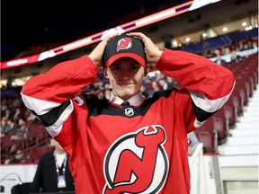 Files: Graeme Clarke tries on a Devils cap after becoming the 80th overall pick in the 2019 NHL draft