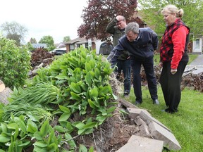 Ottawa Mayor Jim Watson, centre, and Matthew Luloff, Orléans councillor, inspect the tornado damage at Kathy Fleming's house on Mockingbird Drive in Orléans on Monday, June 03, 2019.