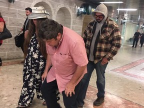Victoria Small, her husband David (bent over in pink shirt), and their son, Jason, are pictured leaving a Newmarket courtroom on June 25, 2019. (Jane Stevenson, Toronto Sun)