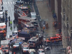 Emergency vehicles are seen outside 787 7th Avenue in midtown Manhattan where a helicopter crashed in New York City, June 10, 2019. REUTERS/Mike Segar