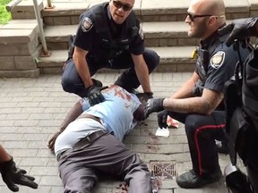 https://www.youtube.com/watch?v=dE6I0V4ki_0 Youtube video screen grabs of Abdirahman Abdi with Const. Daniel Montsion on right, Const. Dave Weir on the left.