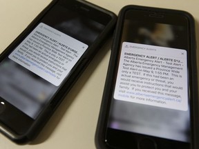 Photo of two Apple iPhones receiving an emergency alert test from the Alberta Emergency Management Agency at the Edmonton Journal in Edmonton, on Wednesday, May 9, 2018.
