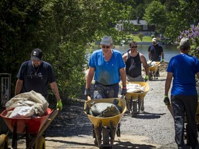 Volunteers, city staff and area residents were out working to clean up the sandbags in Constance Bay Saturday June 8, 2019.