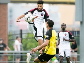 Fury FC's Wal Fall leaps to play the ball away from Steevan Dos Santos of the  Riverhounds during Saturday's USL Championship match in Pittsburgh.