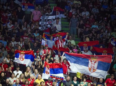 Serbian fans proudly fly flags in the stands at TD Place arena during Sunday's match against Canada.