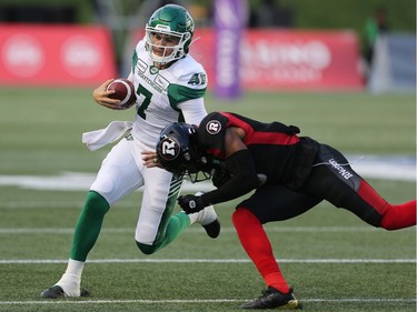 Saskatchewan QB Cody Fajardo tries to avoid a tackle in the first half as the Ottawa Redblacks take on the Saskatchewan Roughriders in CFL action at TD Place in Ottawa. Photo by Wayne Cuddington / Postmedia