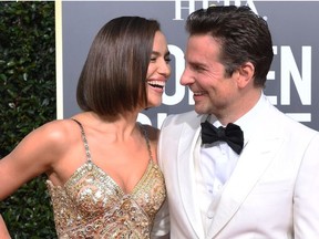 Bradley Cooper (R) and his partner Russian model Irina Shayk arrive for the 76th annual Golden Globe Awards on January 6, 2019, at the Beverly Hilton hotel in Beverly Hills, California.