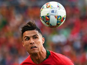 Portugal's forward Cristiano Ronaldo heads the ball during the UEFA Nations League final football match between Portugal and The Netherlands at the Dragao Stadium in Porto on June 9, 2019.