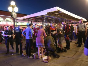 A victim is attended to after a shooting in the ByWard Market near the Moulin De Provence Cafe on Friday, June 7, 2019.   Photo by Wayne Cuddington / Postmedia
