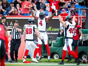 Redblacks quarterback Dominique Davis celebrates after scoring one of his three touchdowns against the Stampeders on Saturday night in Calgary.