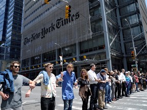 Activists from the group Extinction Rebellion block traffic on 8th Avenue in front of the New York Times building and the Port Authority Bus Terminal near Times Square in the Manhattan borough of New York City, U.S., June 22, 2019. (REUTERS/Jefferson Siegel)