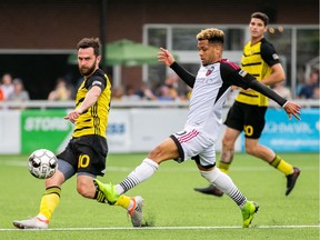 Ottawa Fury FC's Kevin Oliveira, right, left-foots the ball past Kevin Kerr (10) of Pittsburgh Riverhounds SC during a United Soccer League Championship match in Pittsburgh on Saturday, June 8, 2019. The match ended in a 2-2 draw. Chris Cowger / Pittsburgh Riverhounds SC