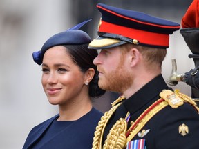Meghan, Duchess of Sussex and Prince Harry, Duke of Sussex make their way in a horse drawn carriage ahead of the Queen's birthday parade, 'Trooping the Colour', in London on June 8, 2019. (DANIEL LEAL-OLIVAS/AFP/Getty Images)