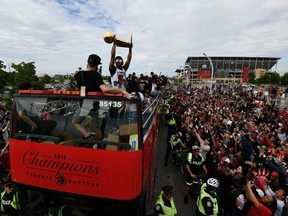 Toronto Raptors guard Kyle Lowry raises the Larry O'Brien NBA Championship Trophy during Raptors victory parade celebration in Toronto, June 17, 2019. REUTERS/Moe Doiron